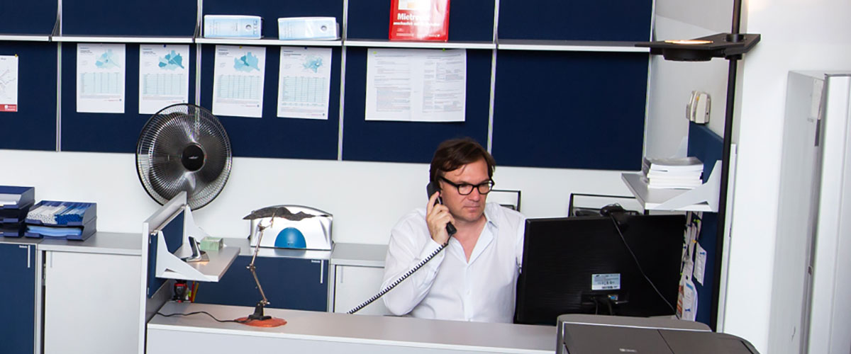 Immobilien-Suche Stefan Polke im Büro vor dem Bildschirm bei der telefonischen Recherche.